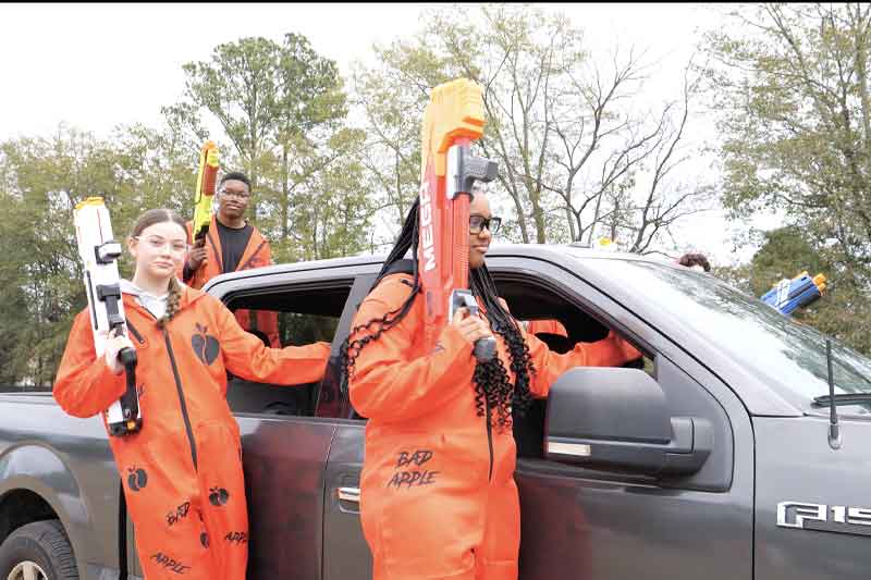 kids riding on truck holding nerf guns at Blue Apple event